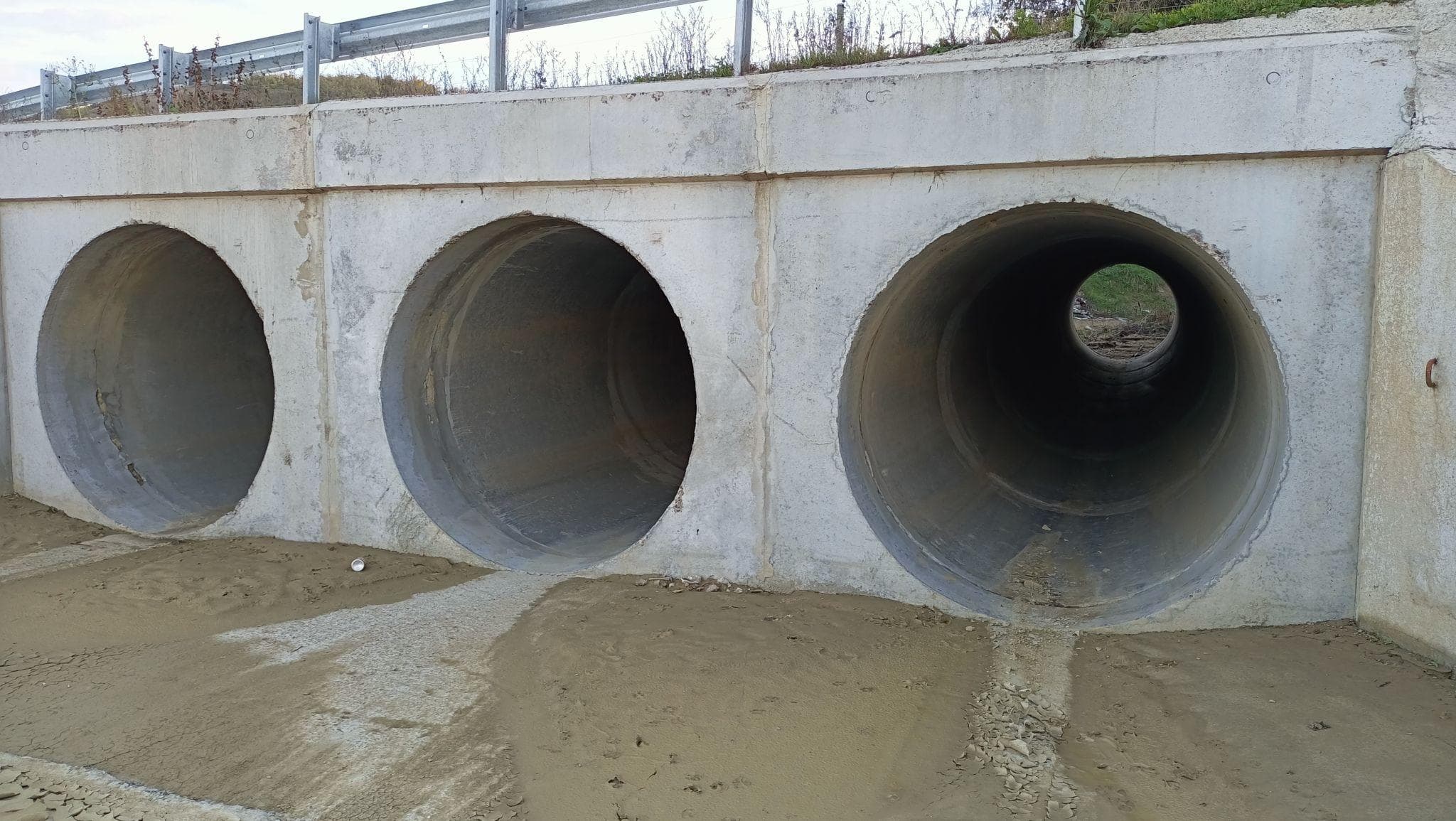 Concrete culvert installed for drainage under access road